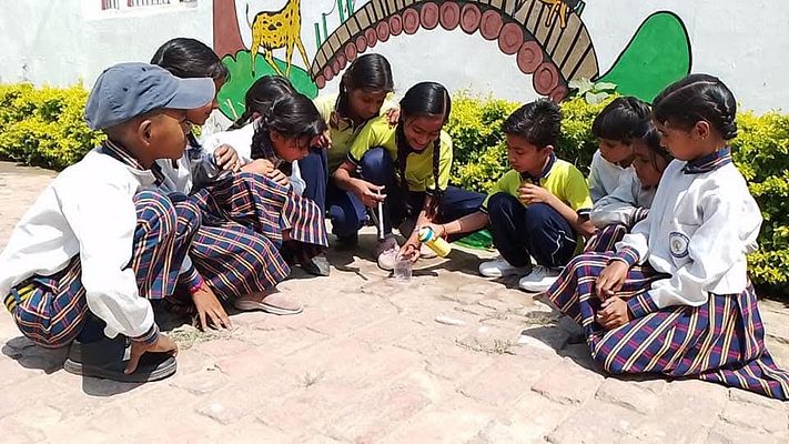 Teacher and students building community spirit